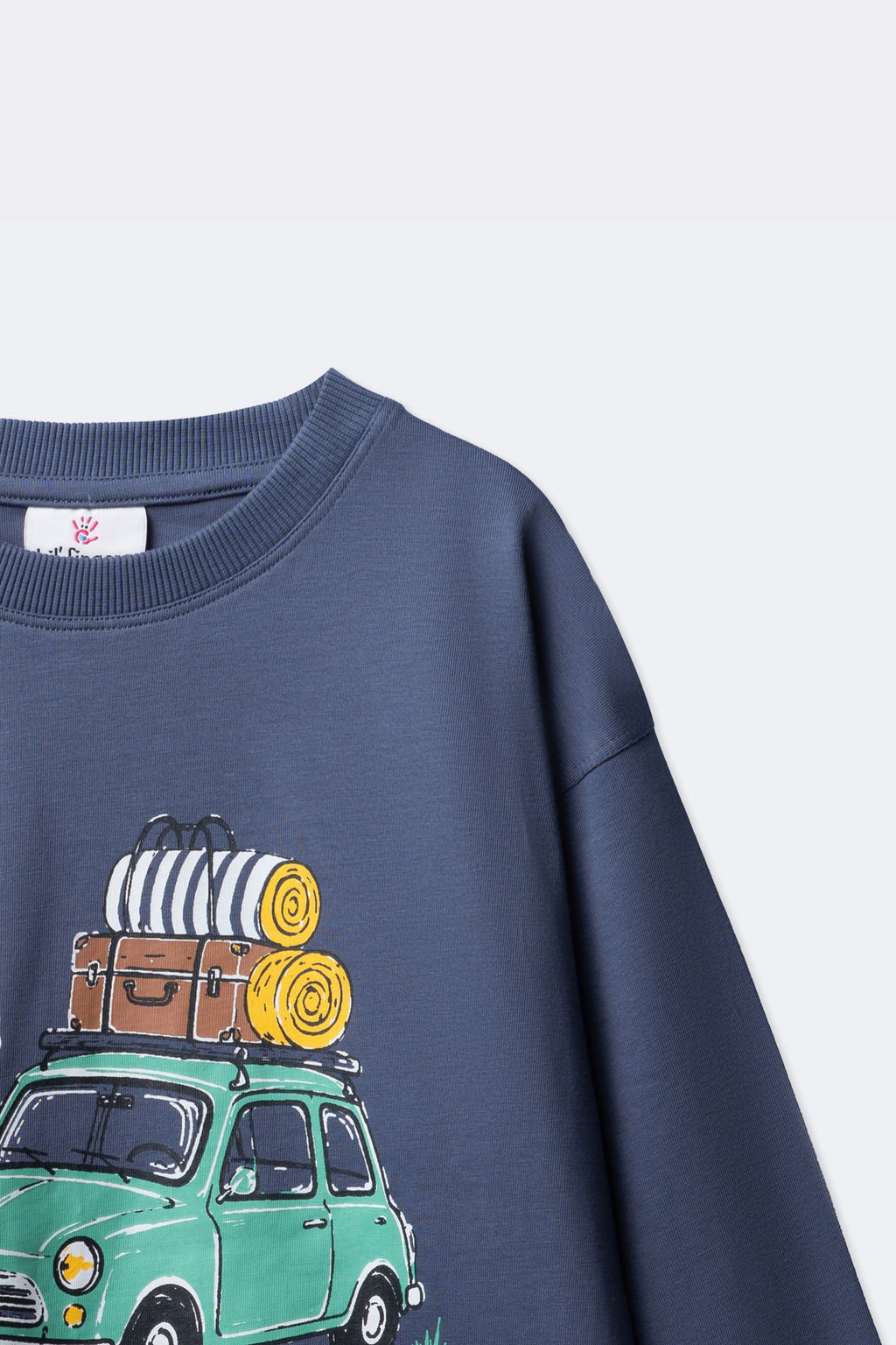 Dusty blue long-sleeve tee with partial Little Road Stories bus print