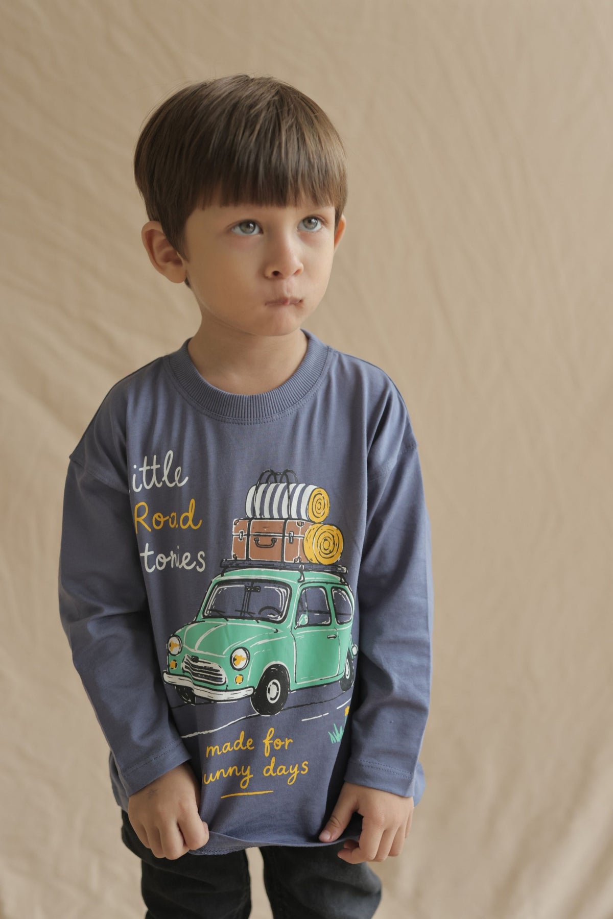 Dusty blue long-sleeve tee with Little Road Stories bus graphic on child