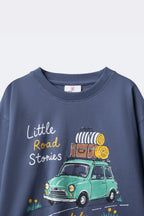 Dusty blue long-sleeve tee with Little Road Stories bus and grass details