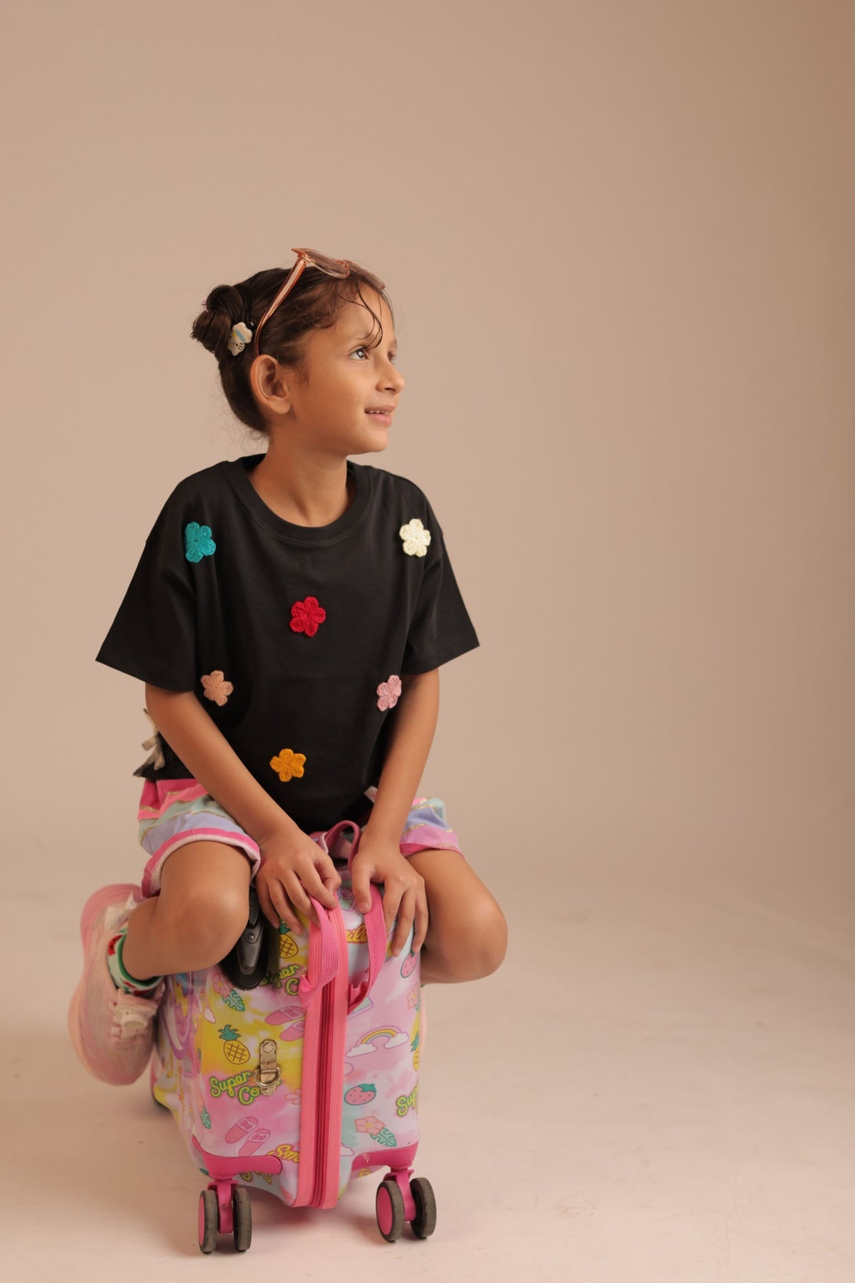 Black tee with colorful crochet flower appliques on front and sleeves