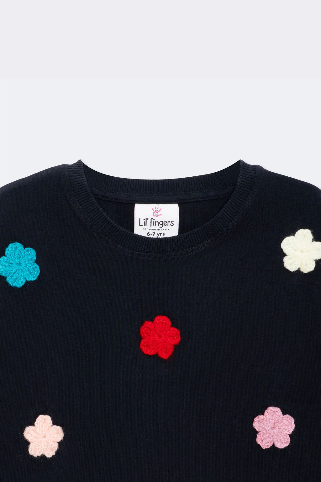 Black tee with embroidered crochet flowers on chest, crew neckline