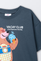 Kids round-neck comfort tee, blue, close-up collar and “VACAY CLUB” front bear graphic