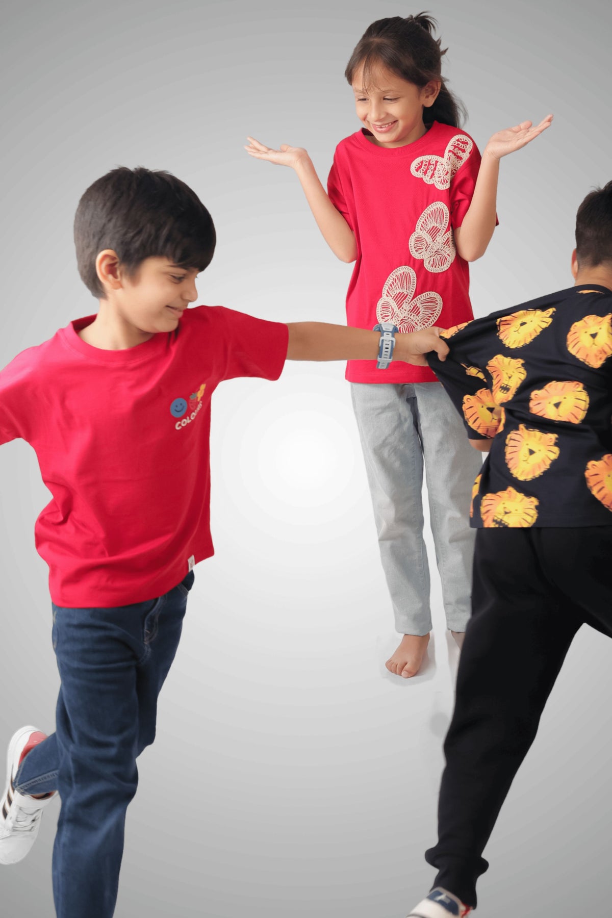 Kids wearing red COLOURS graphic T-shirts