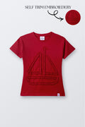 Red round-neck comfort tee with sailboat-shaped embroidery on front