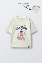 Off-white comfort tee with colorful lighthouse and 'Champions' front graphic