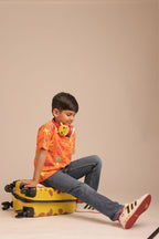 Orange kids all-over print tee worn by child, short sleeves and round neck
