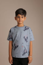 Boy wearing light blue all-over lobster print comfort tee with red accent details