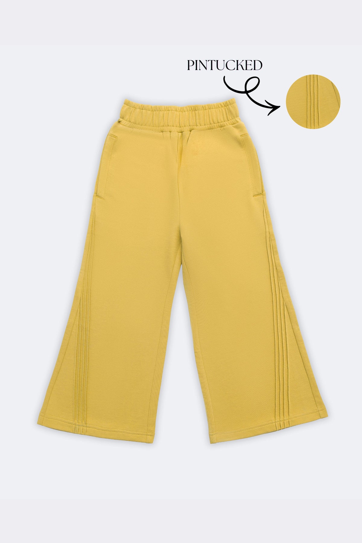 Yellow palazzo pants with slant pintuck detailing on both sides, elastic waistband