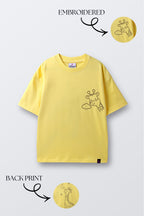 Yellow comfort tee with short sleeves and stitched character graphic on the chest