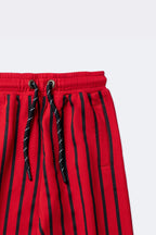 Red and black striped track pants with drawstring and side pocket
