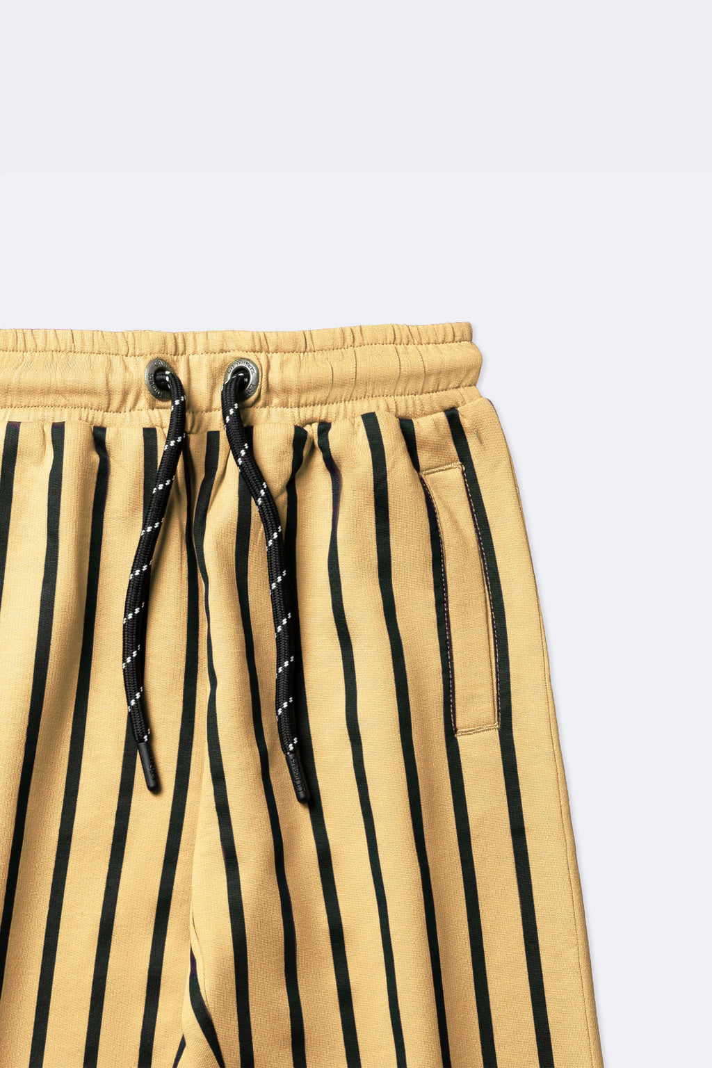 Elastic waistband with black drawstring and side pocket on sand striped track pants