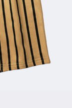 Close-up of sand and black vertical striped track pants fabric and hem