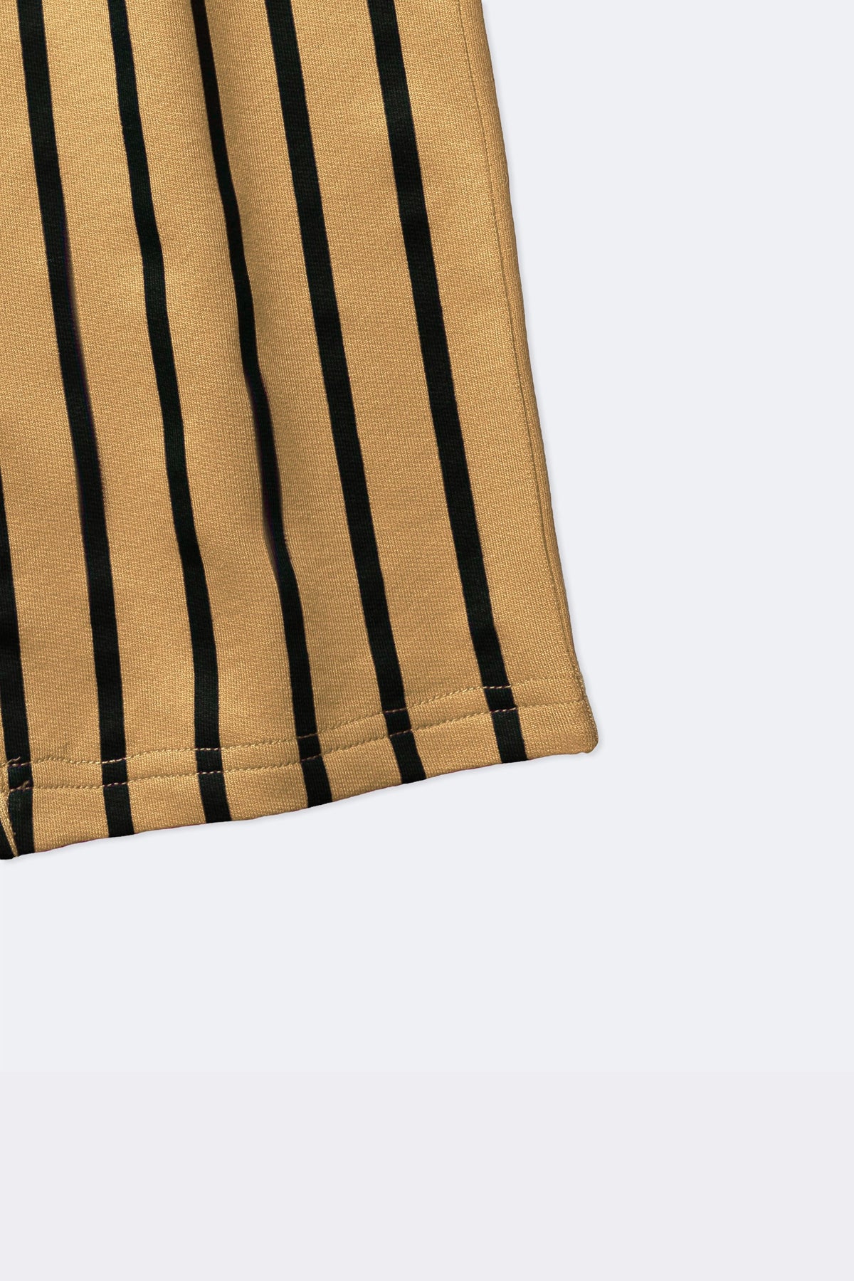 Close-up of sand and black vertical striped track pants fabric and hem