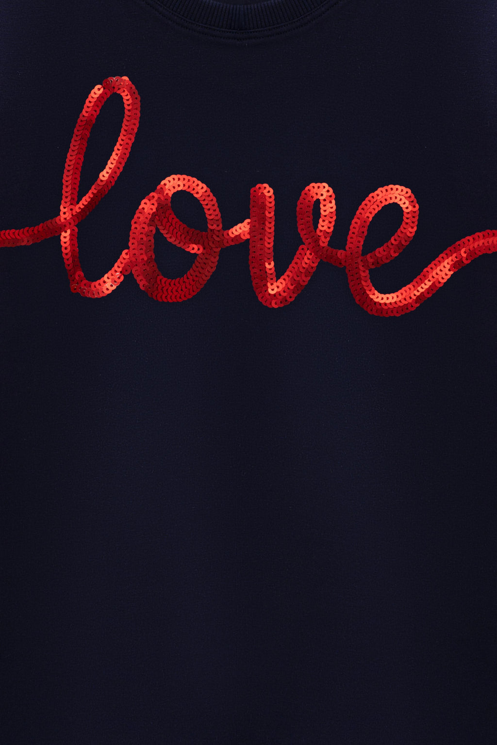 Navy T-shirt close-up of red 'love' lettering graphic