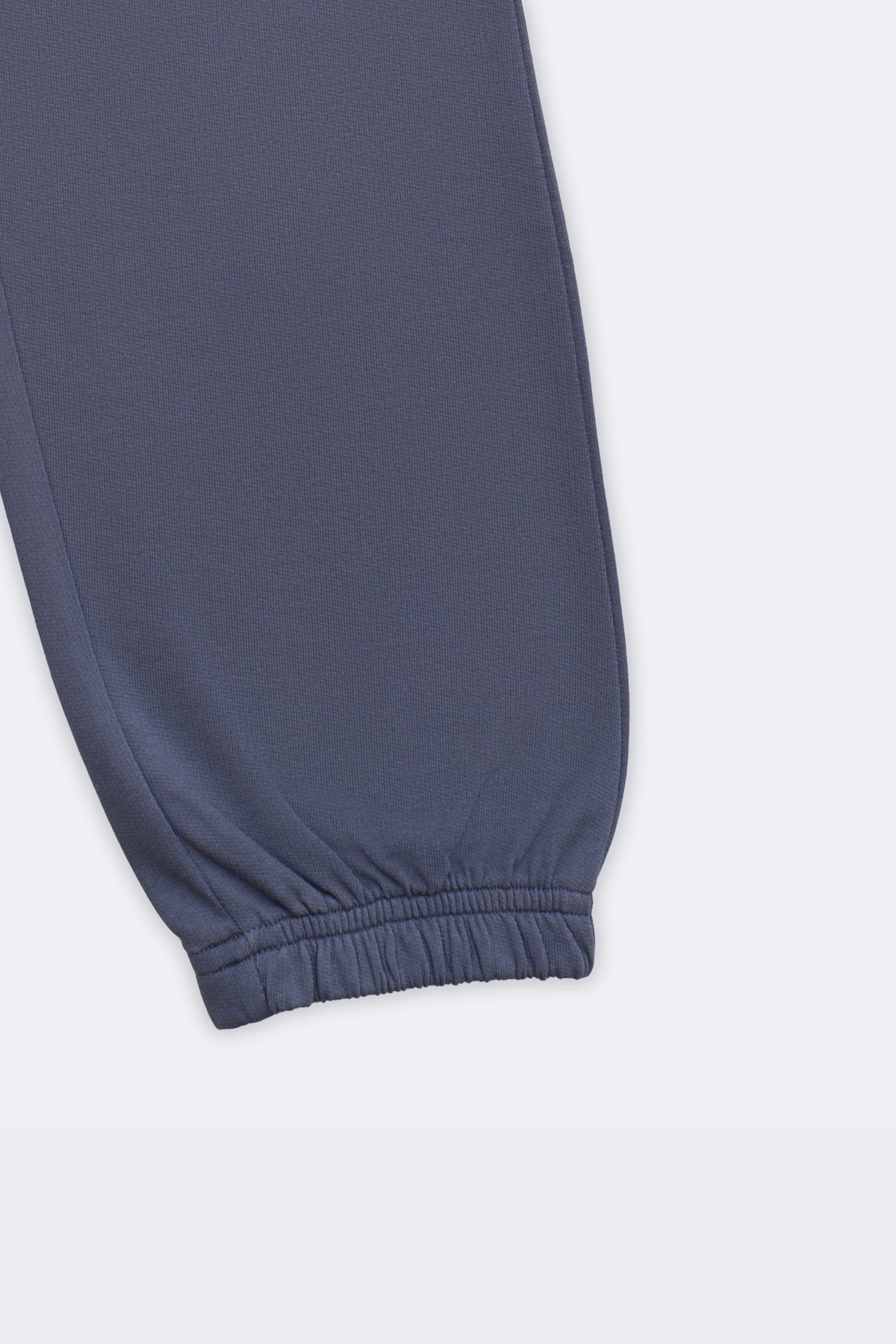 Denim blue track pants with ribbed ankle cuff and smooth jogger hem