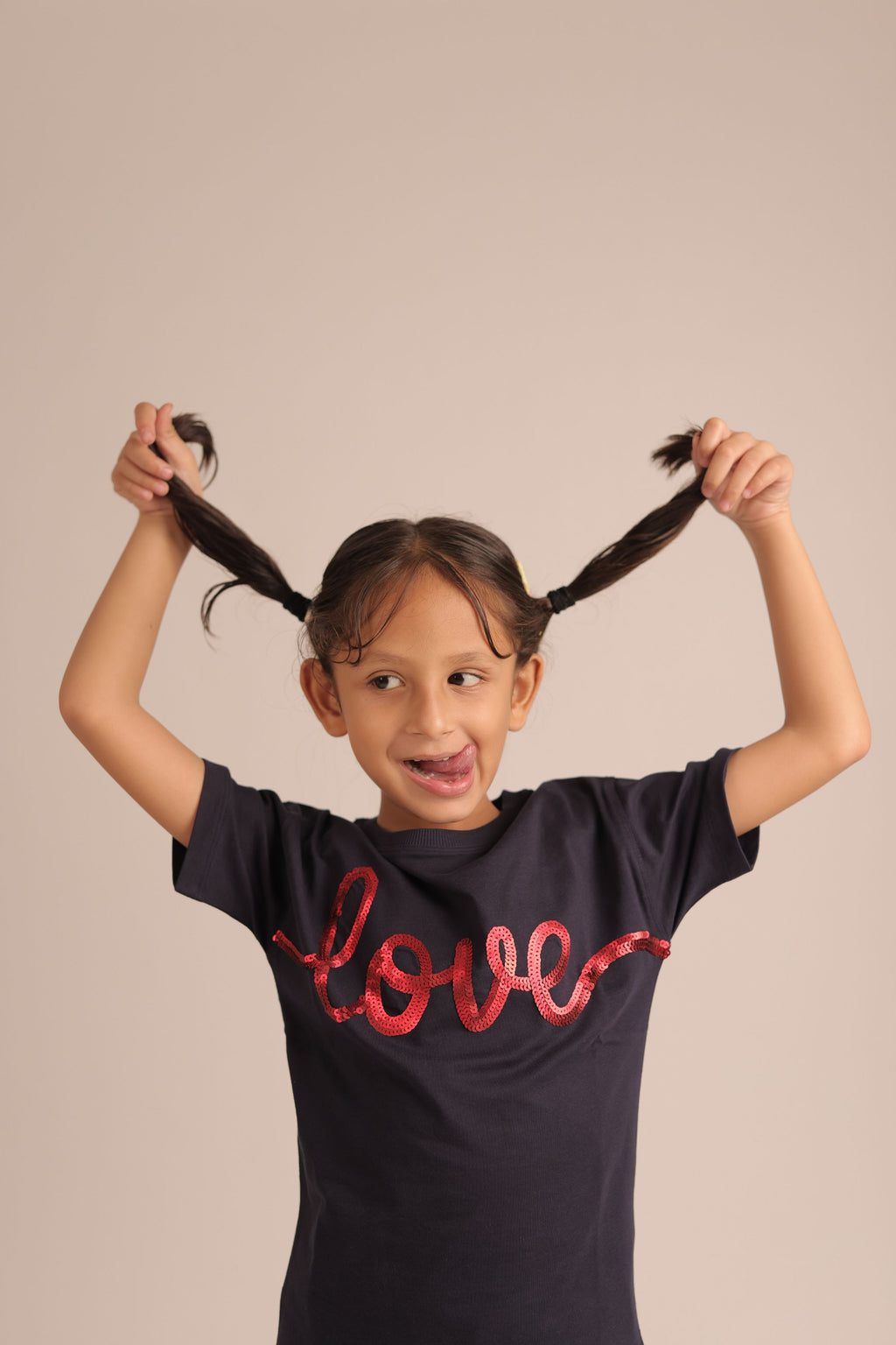Navy children's T-shirt with red 'love' graphic, model wearing