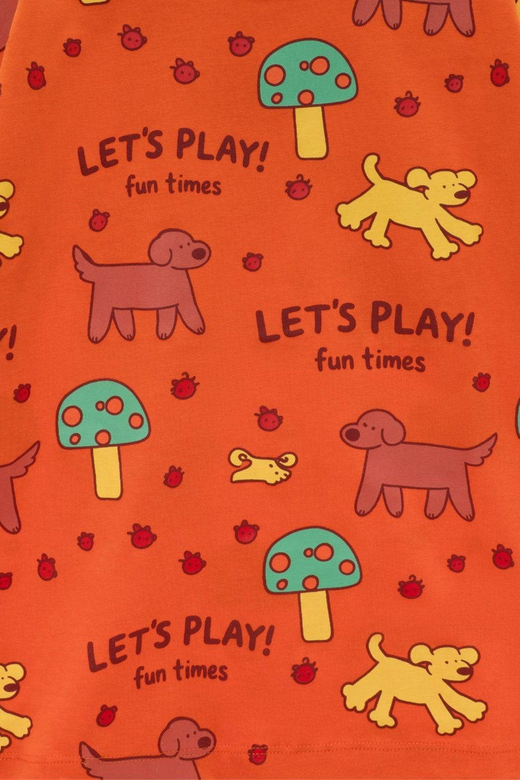 Orange tee close-up pattern: “Let’s Play! fun times” with dogs, bugs, and mushrooms