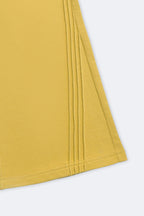 Yellow flared pant hem with vertical slant pintuck detailing and stitched edge