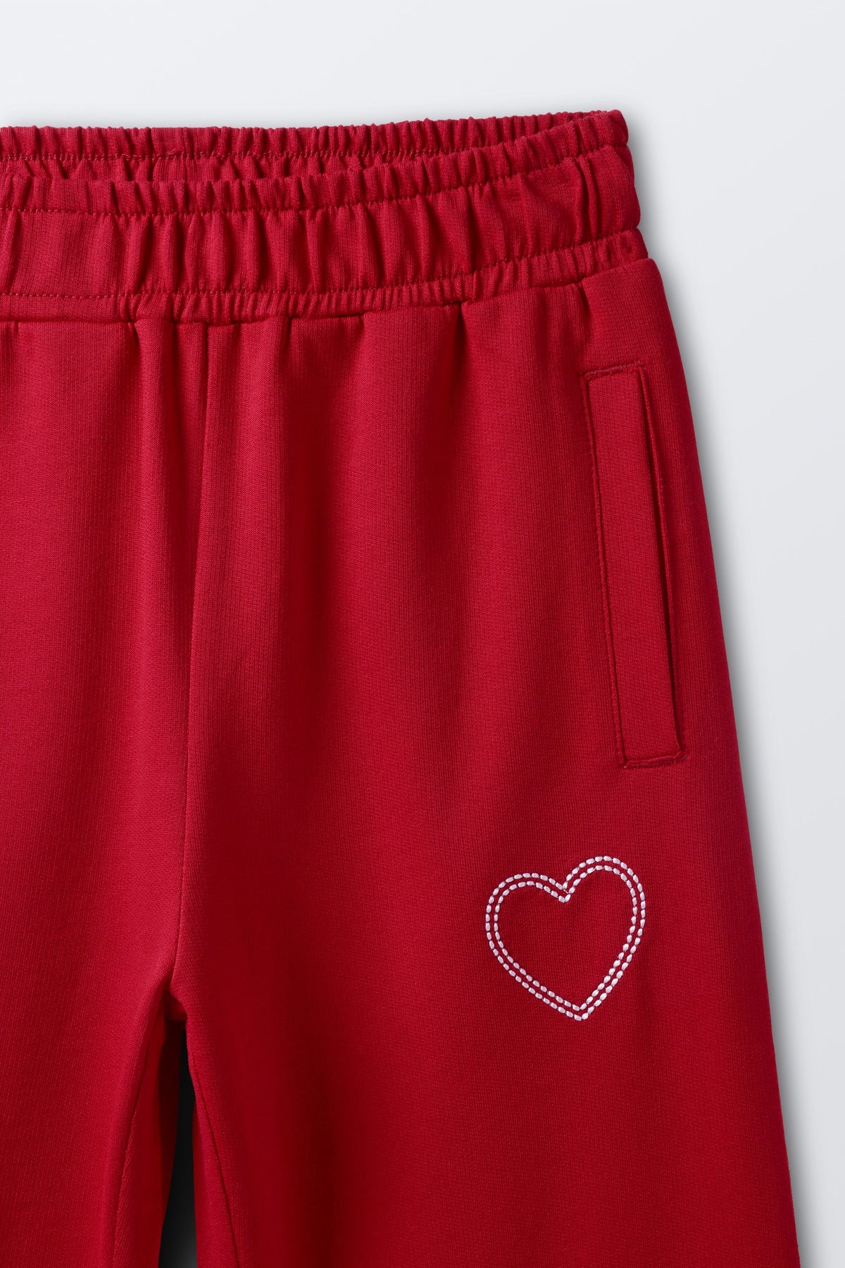 Red palazzo pants with side button tab and heart embroidery