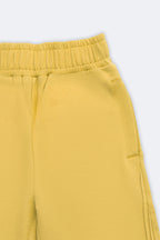 Yellow palazzo pants with elastic waist, side slant pintucks, and welt pocket detail