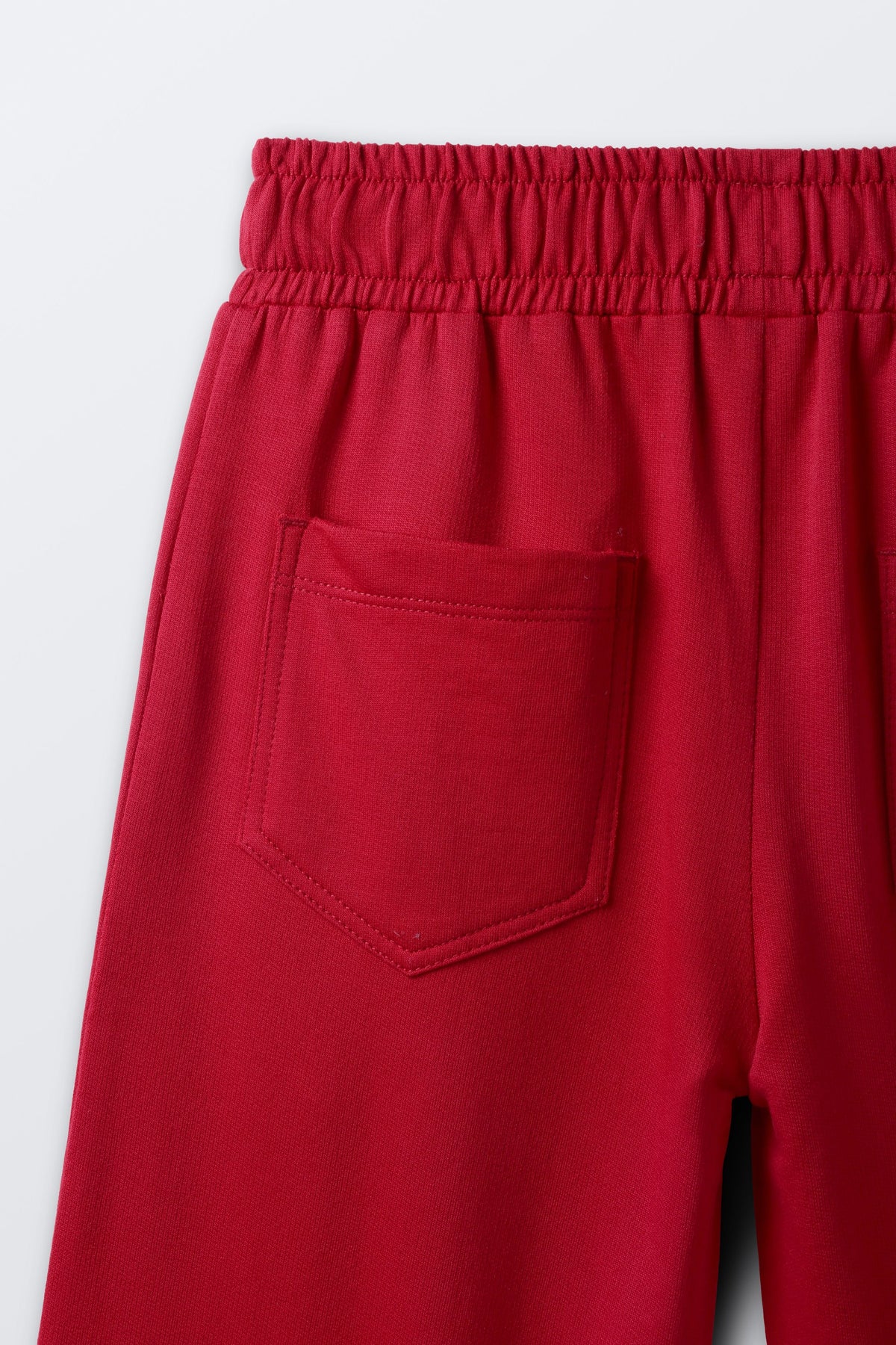 Red palazzo pants with elastic waist and stitched side pocket detail