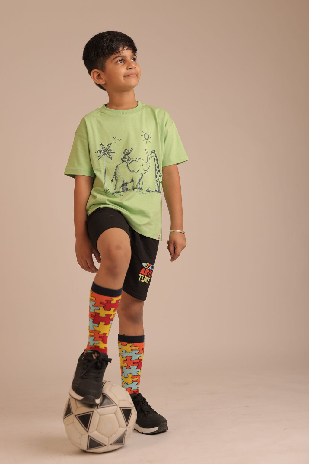 Lime green kids comfort tee with small jungle animal print on the chest