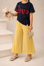 Yellow wide-leg palazzo pants with elastic waistband and vertical slant pintucks