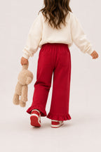 Red palazzo pants with ruffled hem, side pockets, and heart embroidery