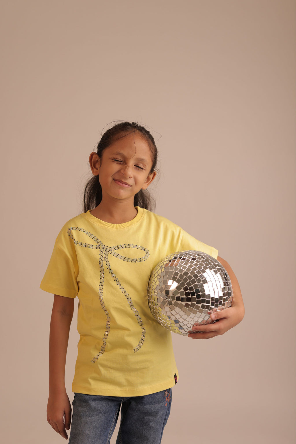 Yellow short-sleeve tee with beaded bow embroidery across the front