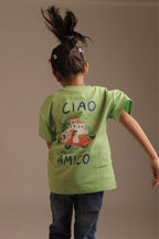 Back of kids green tee with “CIAO AMICO” text and scooter graphic, palm scene