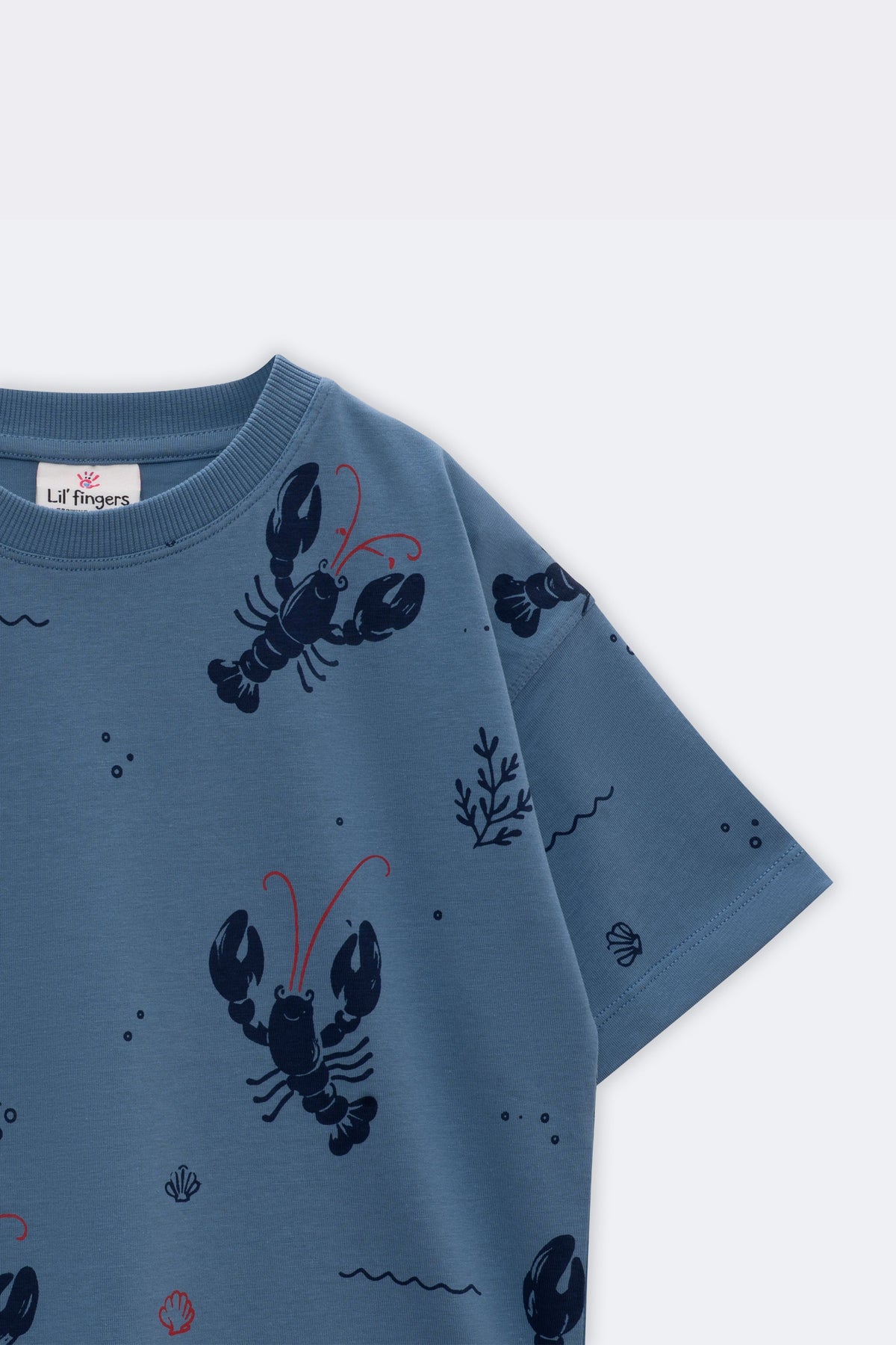 Light blue short-sleeve crew tee with lobsters, waves, and coral accents all over