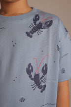 Light blue crew-neck comfort tee with all-over lobster print and red accents