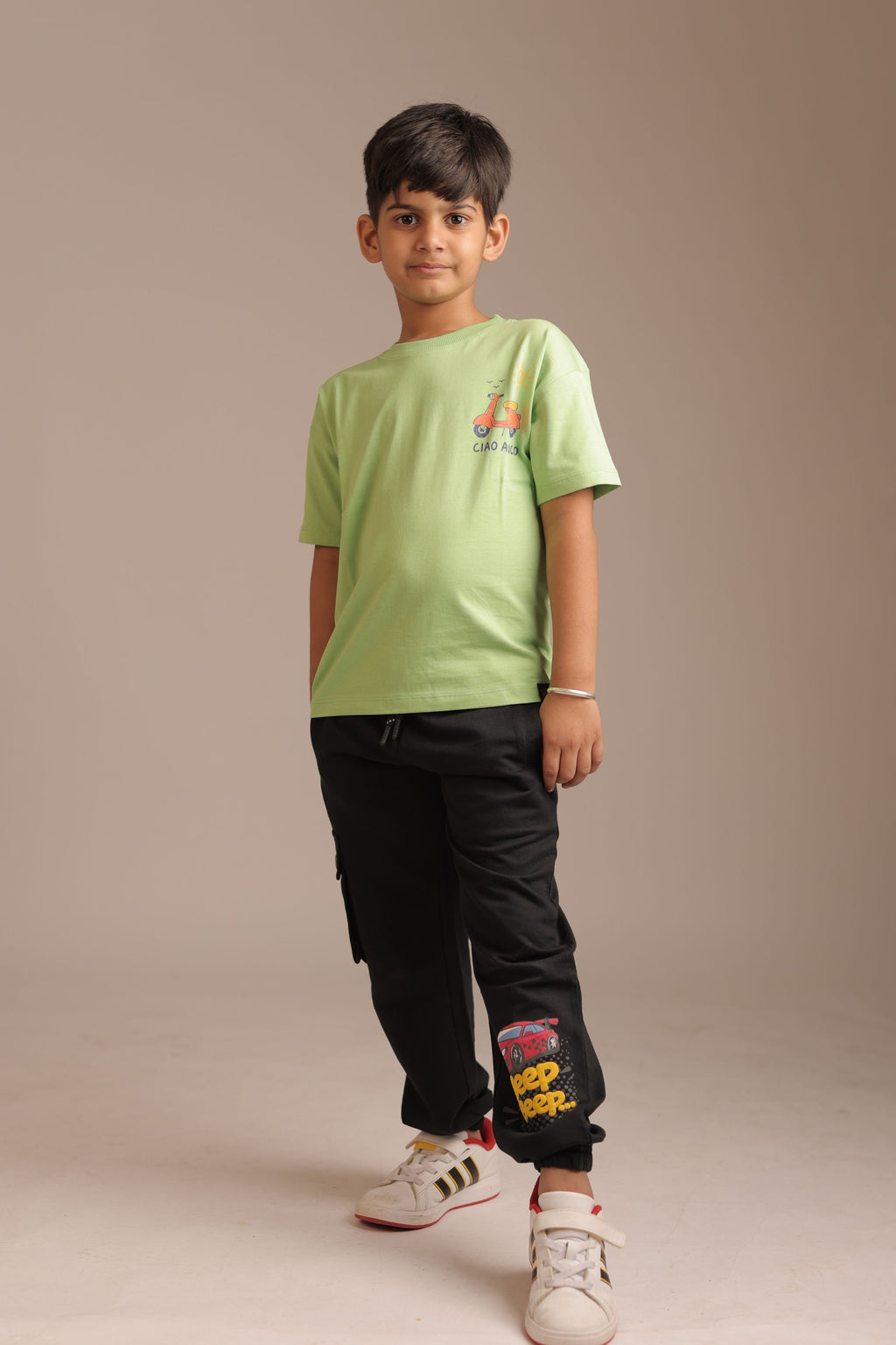 Kids green comfort tee with small scooter “CIAO AMICO” logo on chest