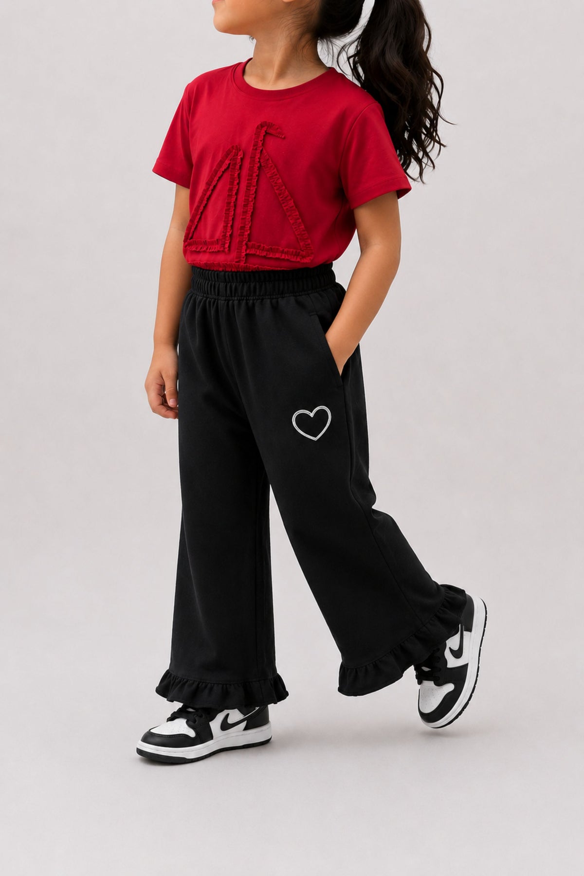 Black flared palazzo pants with heart embroidery on thigh and ruffled cuffs