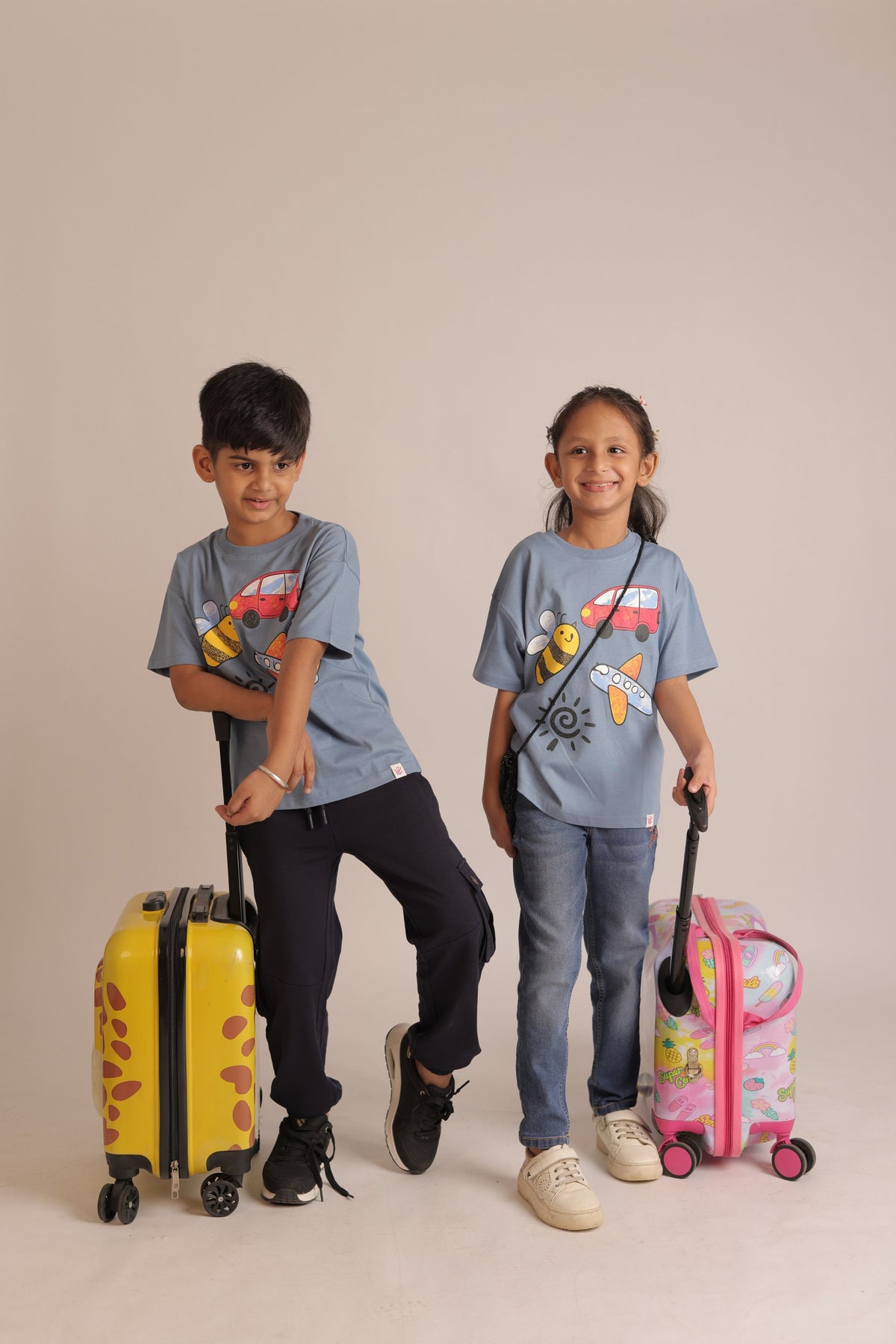 Blue comfort tee with colorful crayon-style bus, bee, plane and sun graphic