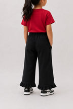 Black flared palazzo pants with elastic waistband and ruffled hem