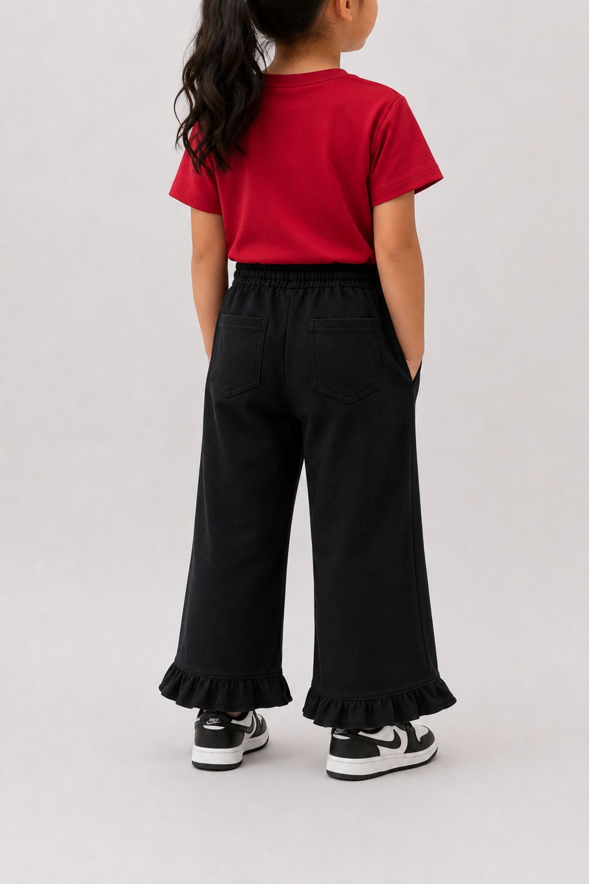 Black flared palazzo pants with elastic waistband and ruffled hem