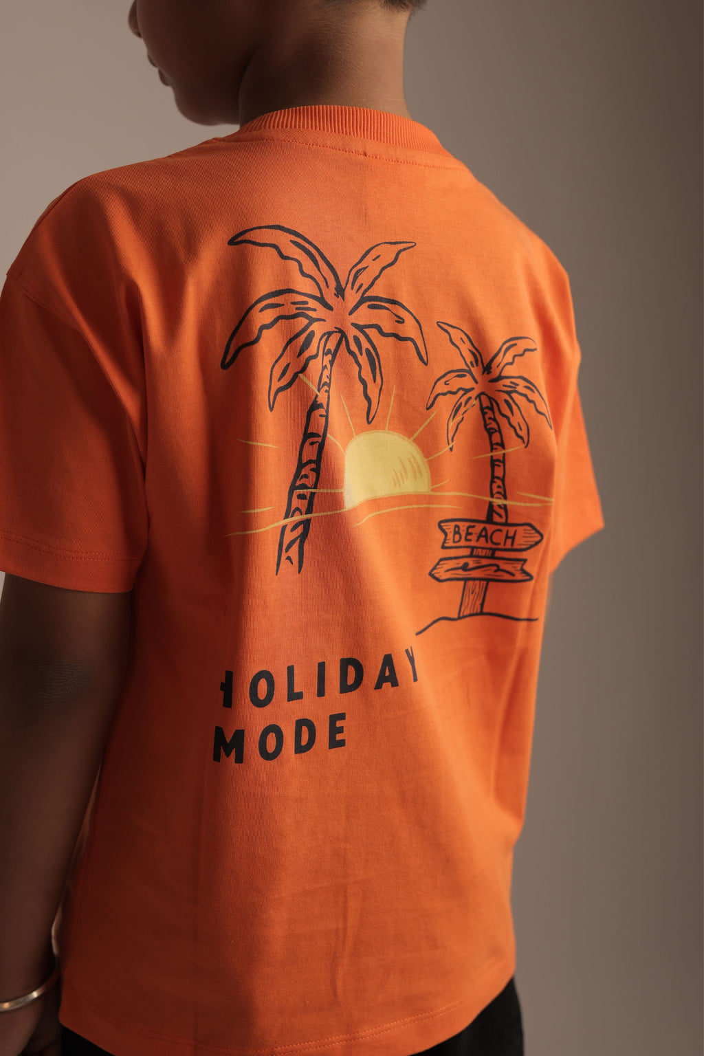 Orange kids' short-sleeve tee with back palm tree graphic and 'Holiday Mode' print
