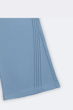 Blue flared palazzo pants with slant pintuck detail at the hem and side seam