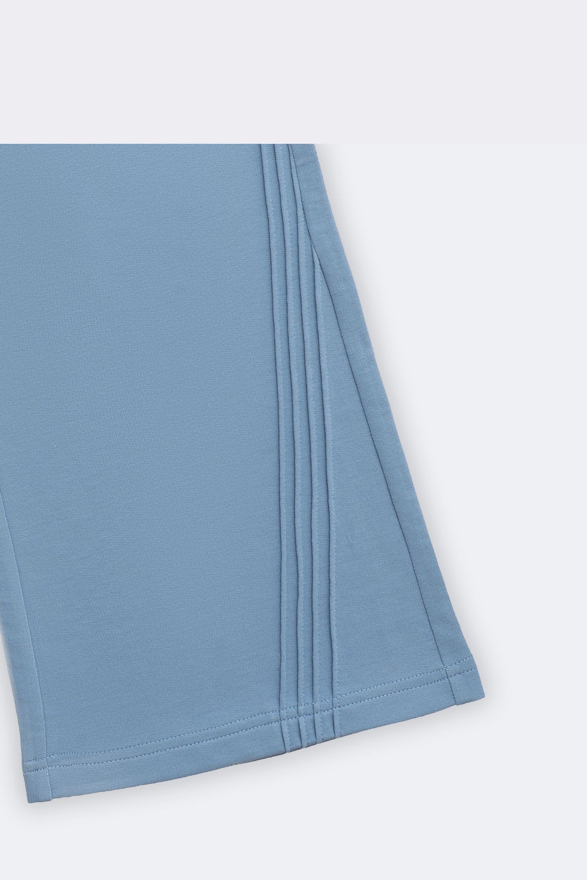 Blue flared palazzo pants with slant pintuck detail at the hem and side seam