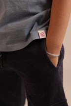 Navy joggers with fabric tag inside pocket seam near hem