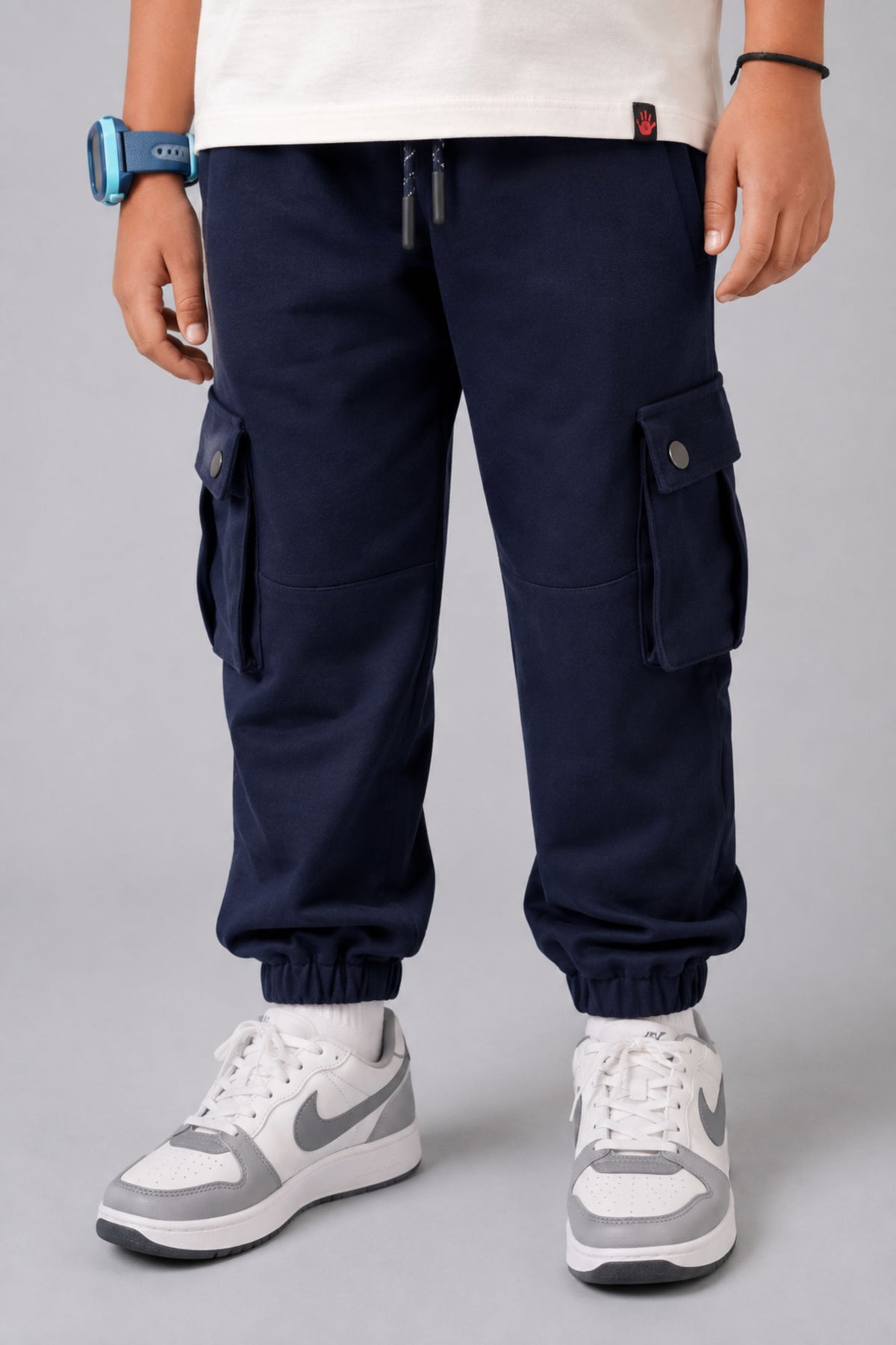 Navy cargo pocket joggers on model, featuring side pockets and elastic ankle cuffs