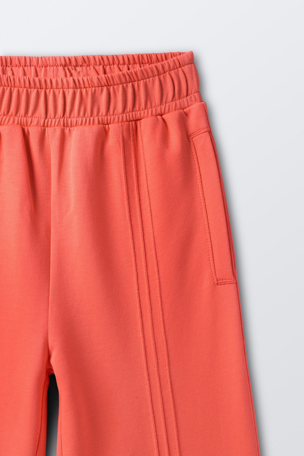 Coral palazzo pants with elastic waistband and vertical pintucked stripes