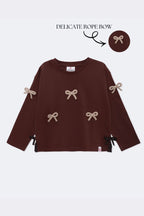 Dark brown long-sleeve kids' tee with beige bow appliques and side ribbon ties
